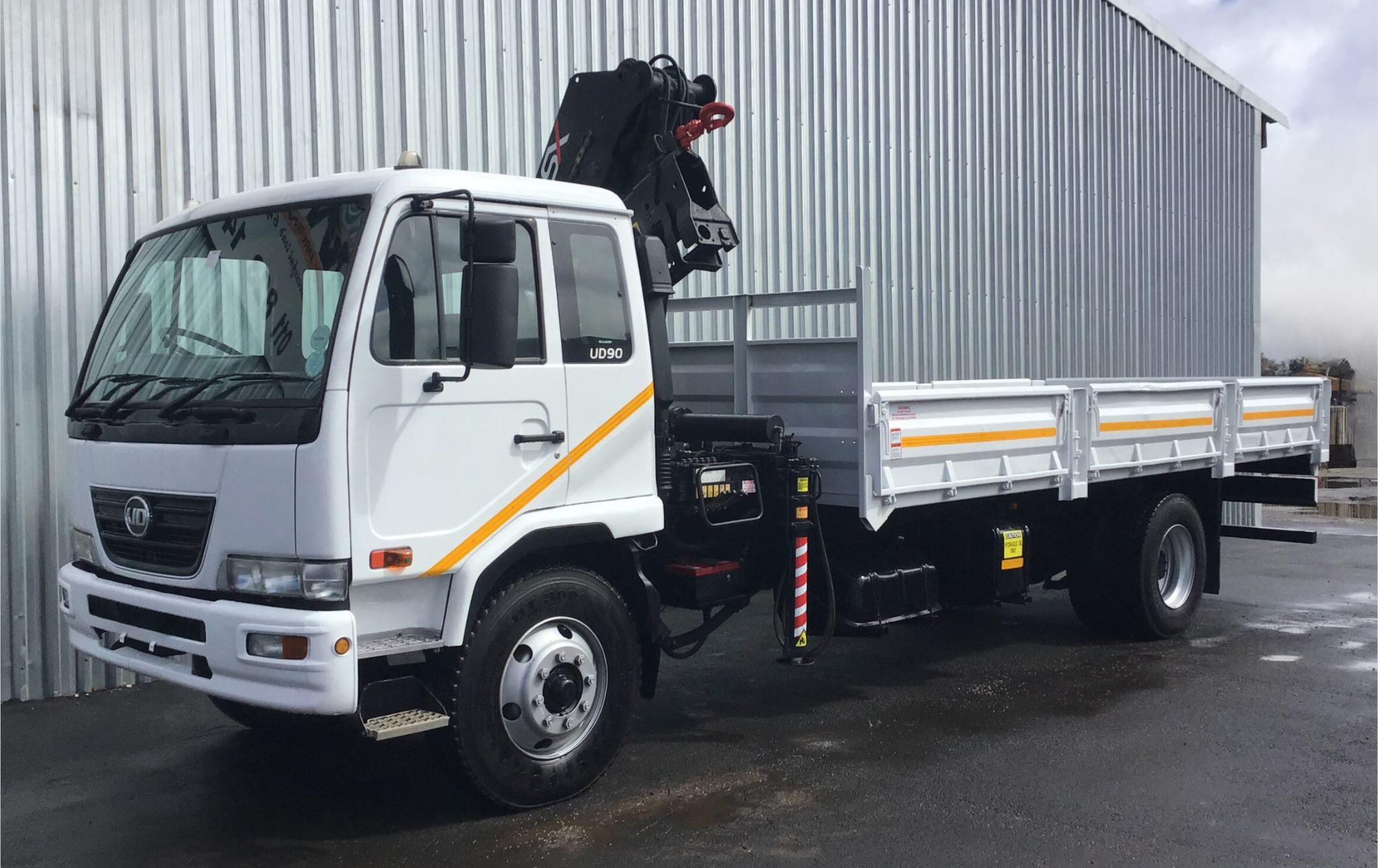 Nissan UD90 dropside crane truck.